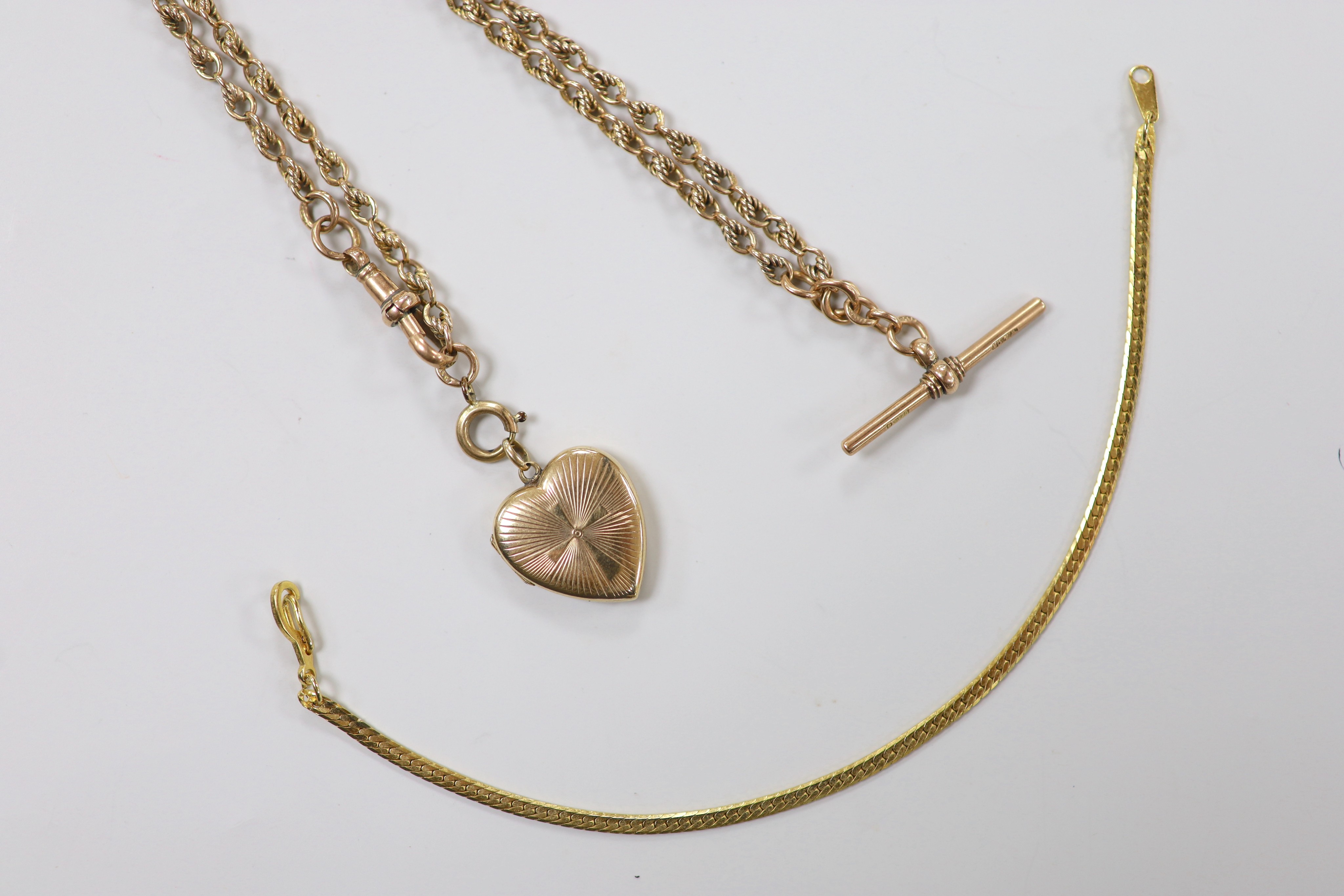 A 1940's 9ct gold heart shaped locket, 21mm, on a 9ct gold fancy link albert, 42cm, gross 18.5 grams, together with a 14k and simulated diamond set bracelet, gross 8.1 grams and one other bracelet.